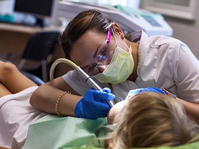 Behandlung: Zahnarzt behandelt einen Patienten im Behandlungszimmer